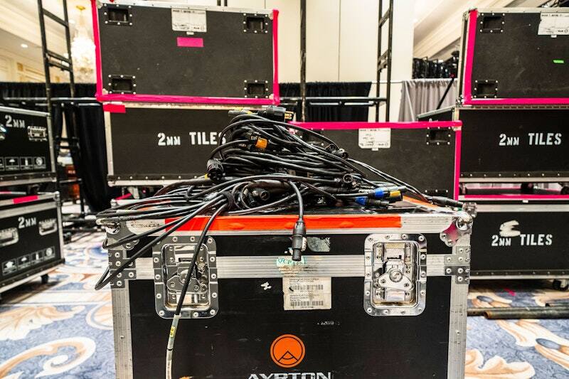 PM1 road cases staged for load-in at an indoor event