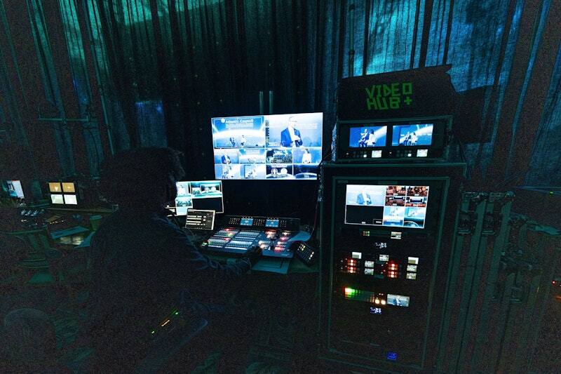 Video switching position with live camera feeds on multiple monitors at a PM1-produced forum