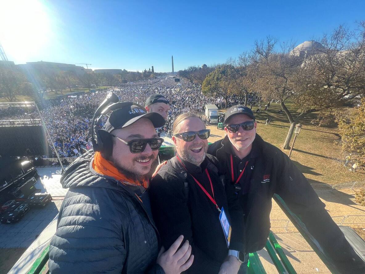 PM1 crew on a camera platform above a crowd on the National Mall