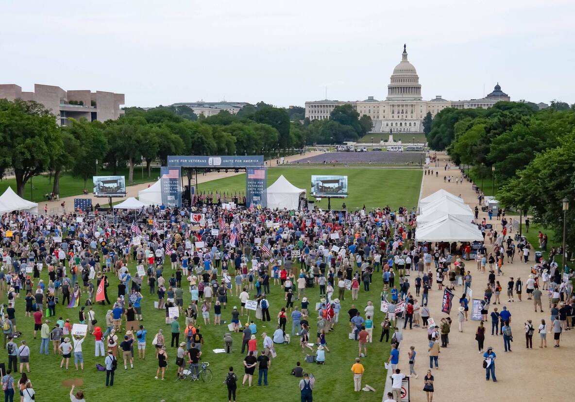 Unite for Veterans crowd on the National Mall facing a PM1 stage, with the U.S. Capitol behind it