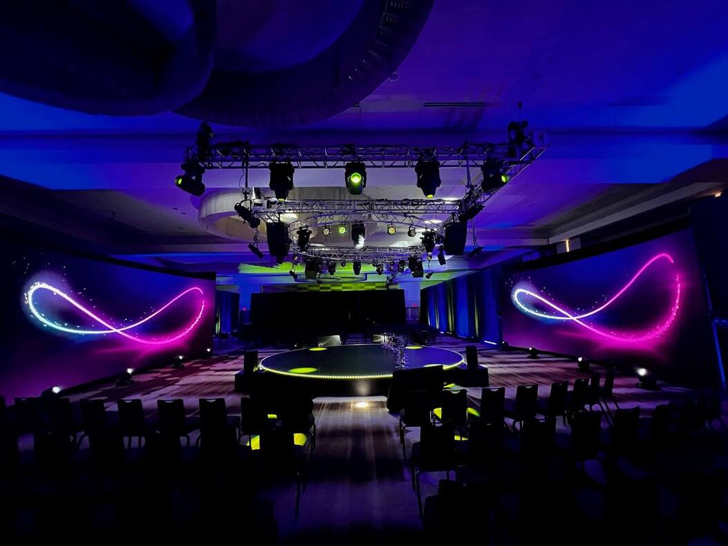 22-foot circular PM1 stage lit in a ballroom set for theater seating