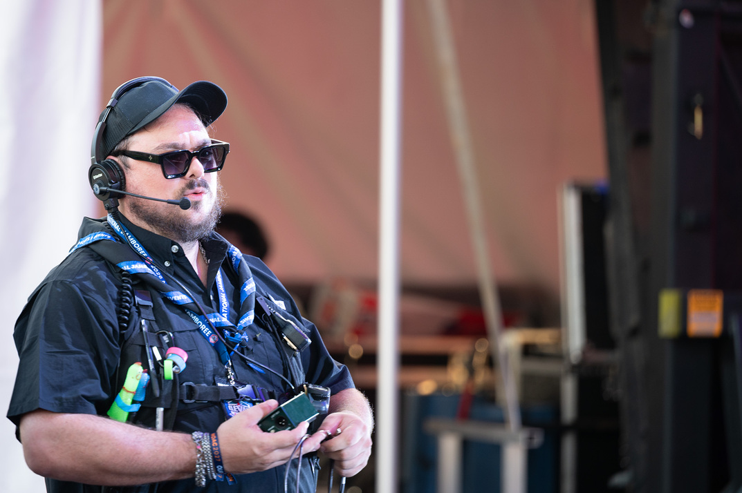 Show caller on headset with a radio, calling cues during a live show
