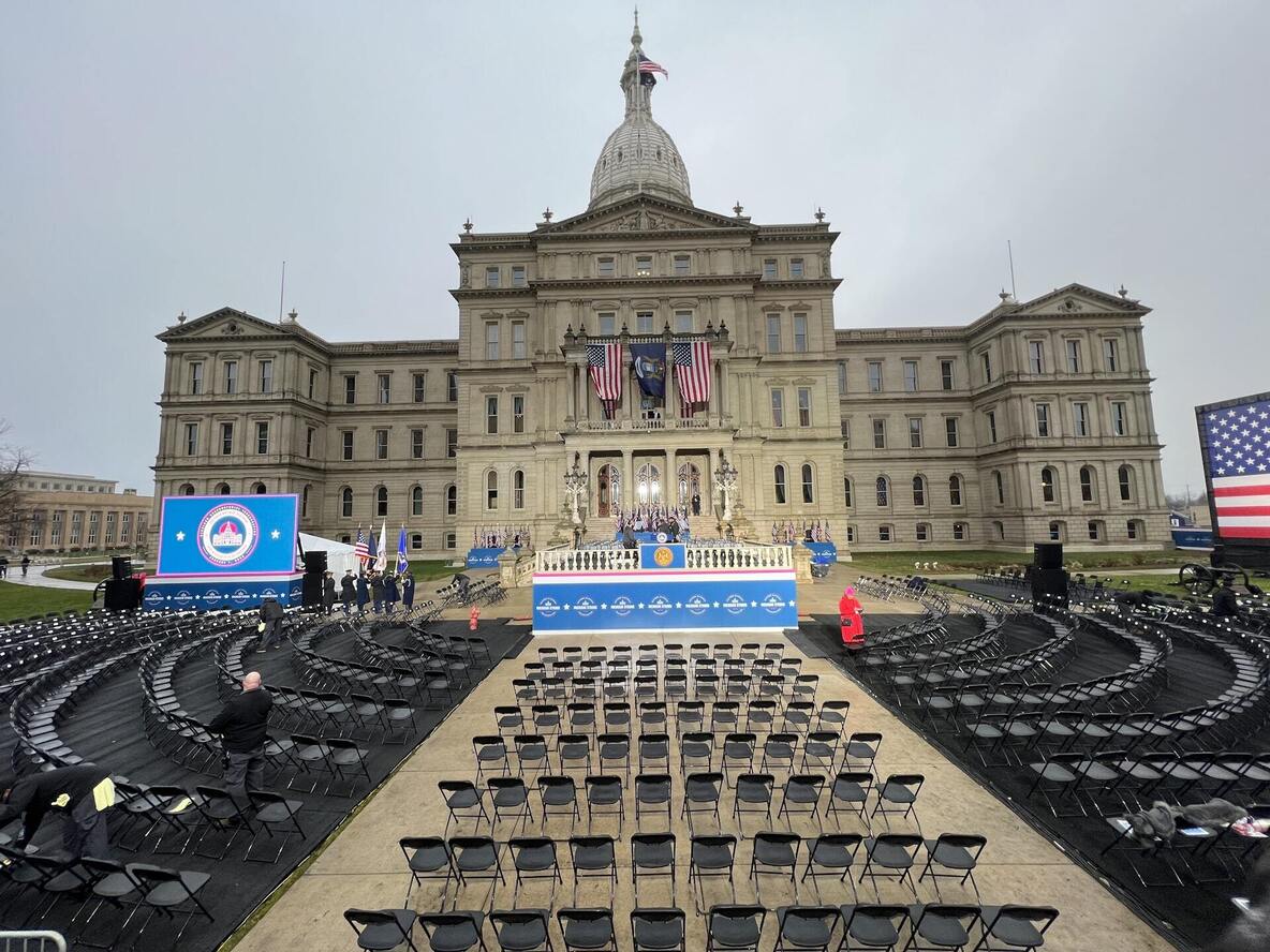 Official ceremony stage and audience seating in front of a state capitol