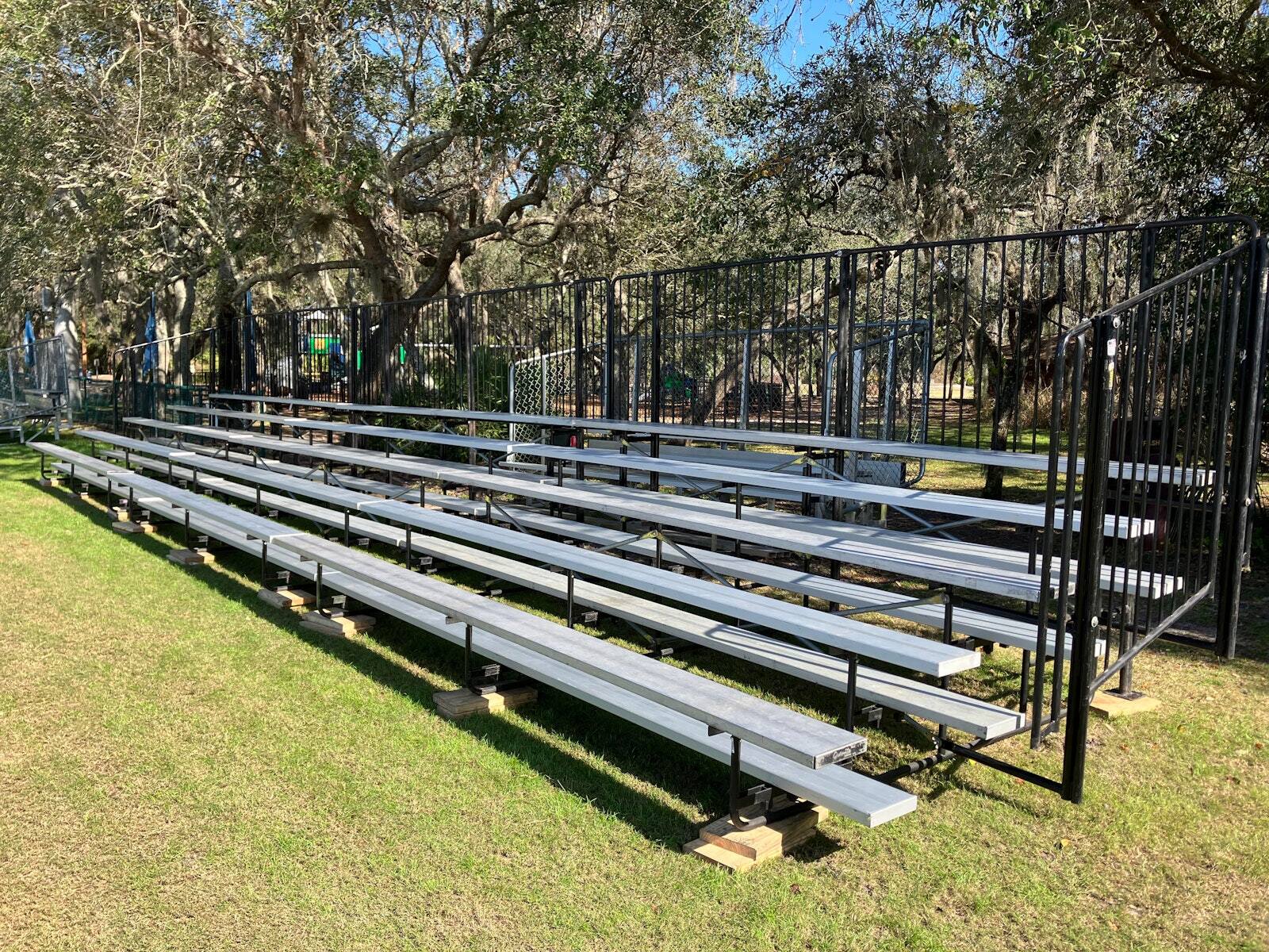 Portable PM1 bleachers set on a grass field
