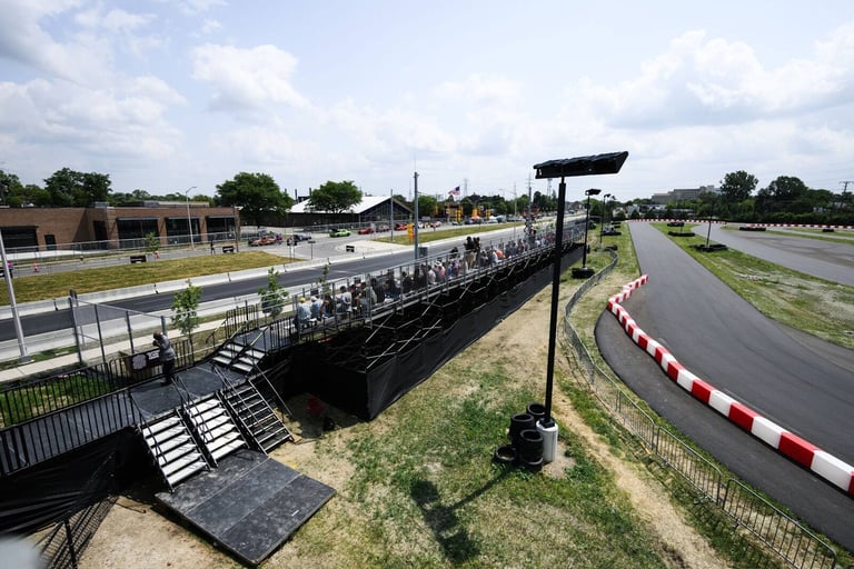 Aerial view of a full PM1 grandstand beside the drag strip at Roadkill Nights