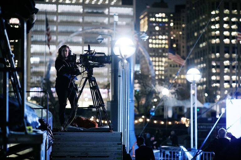 Camera operator on a PM1 camera platform at a night rally in Hart Plaza, Detroit
