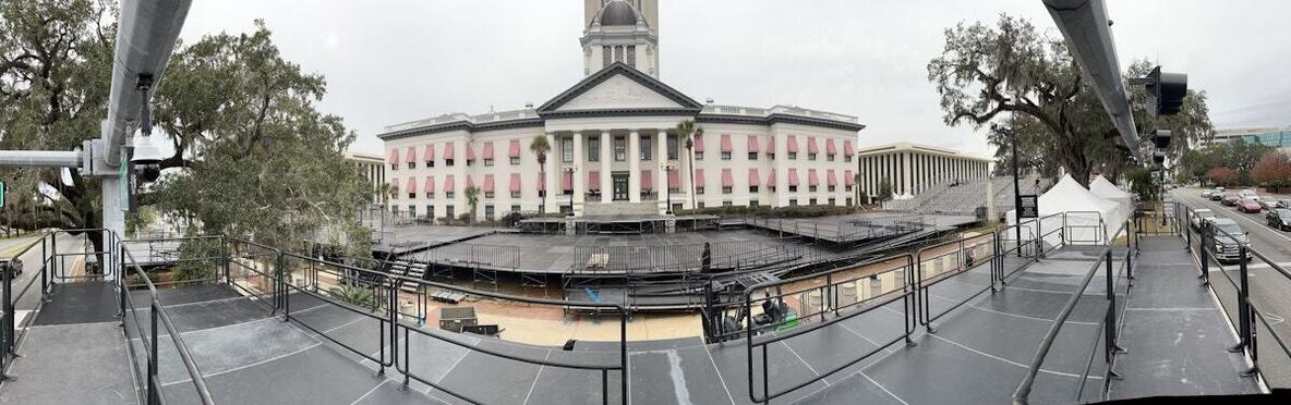 Panoramic view from a PM1 press riser of stage platforms in front of a state capitol