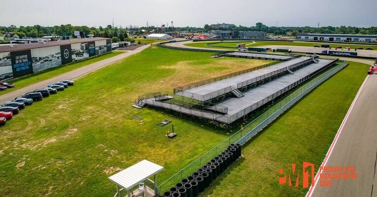Aerial view of a long PM1 VIP viewing deck with stairs and railings beside the track at M1 Concourse