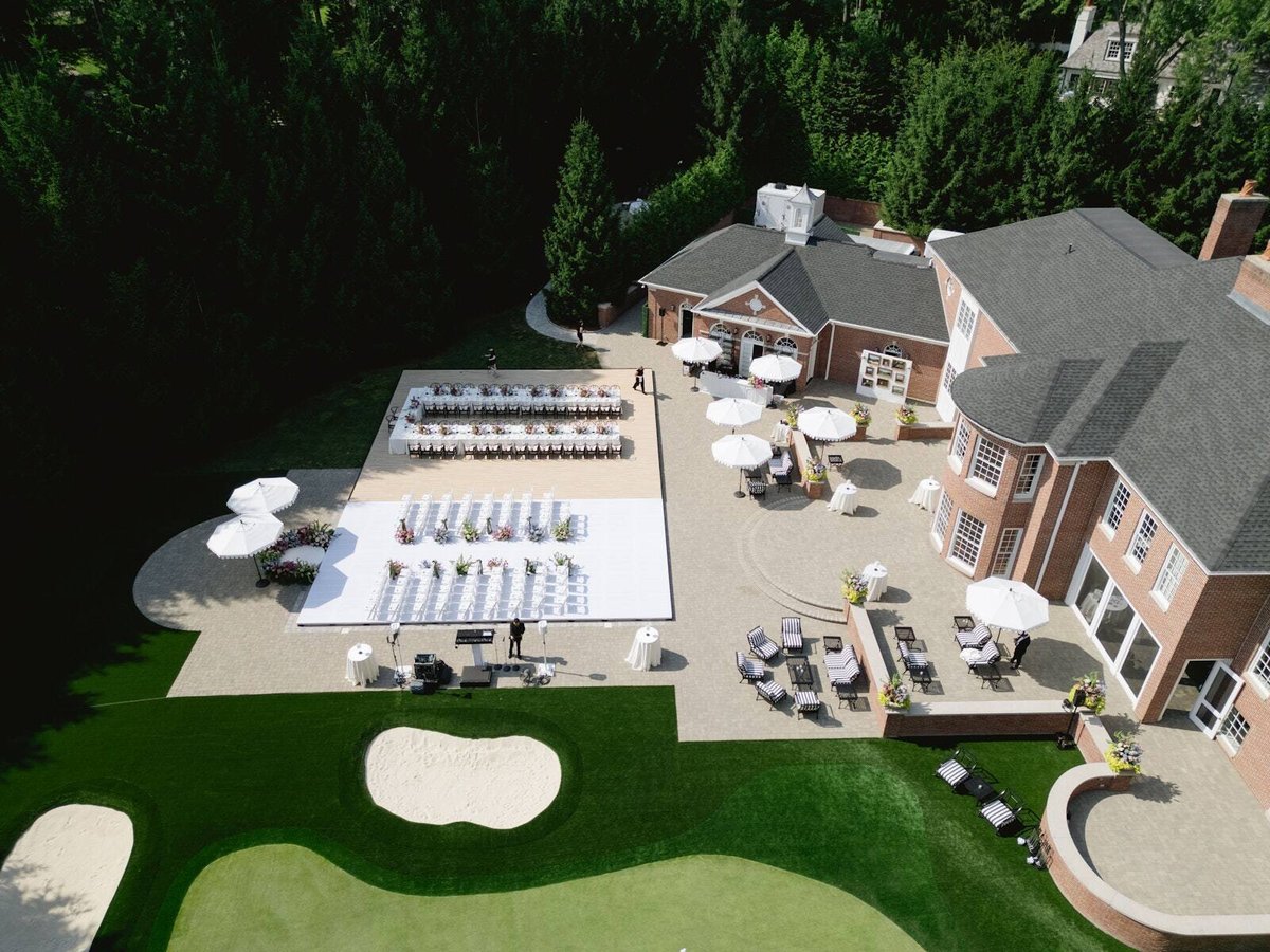 Aerial view of a Detroit-area estate with the event set up around the PM1 pool cover
