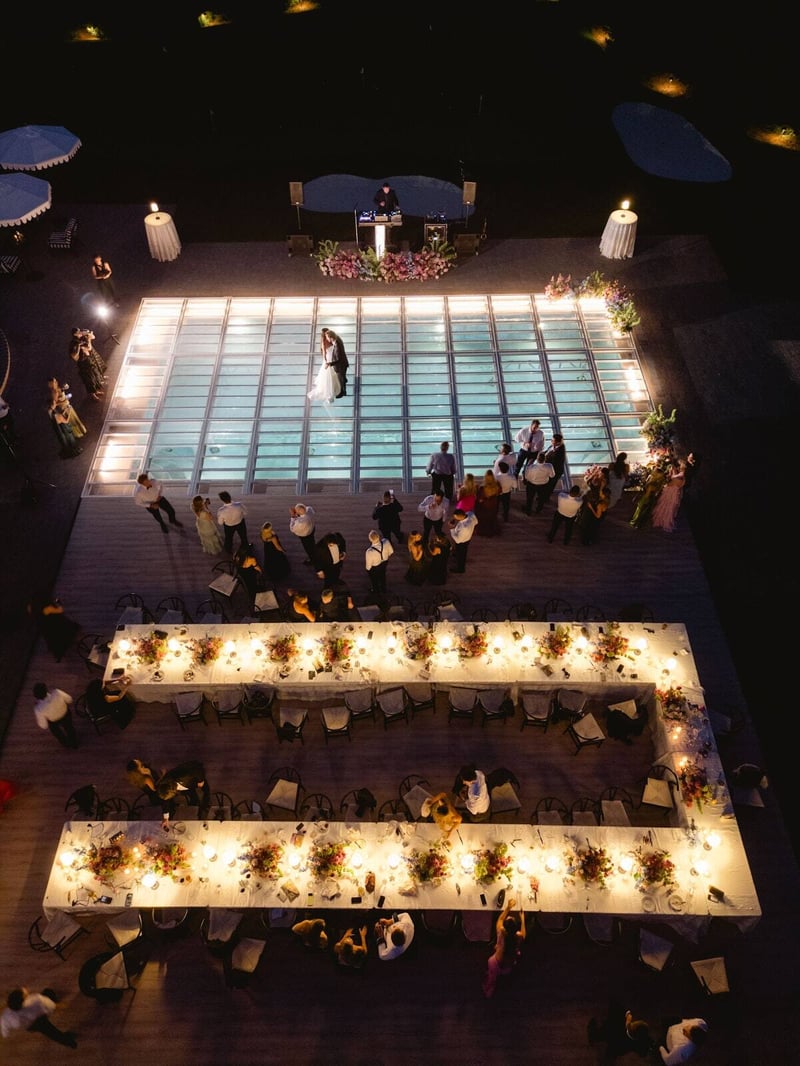 Night wedding reception around an illuminated pool at a Detroit-area estate