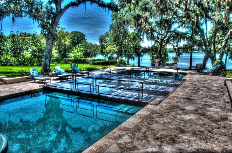 Raised PM1 pool cover platform with metal handrails over a private pool in Fort Myers