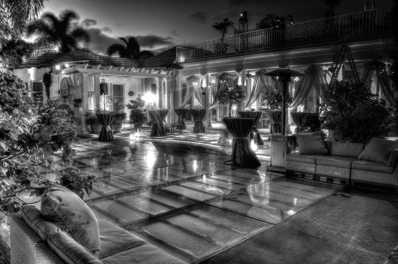 Black and white night view of a patio event on a reflective PM1 pool cover floor