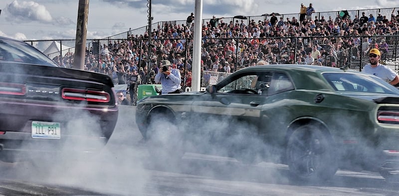 Muscle cars launching in front of packed grandstands at Roadkill Nights on Woodward Avenue, Detroit
