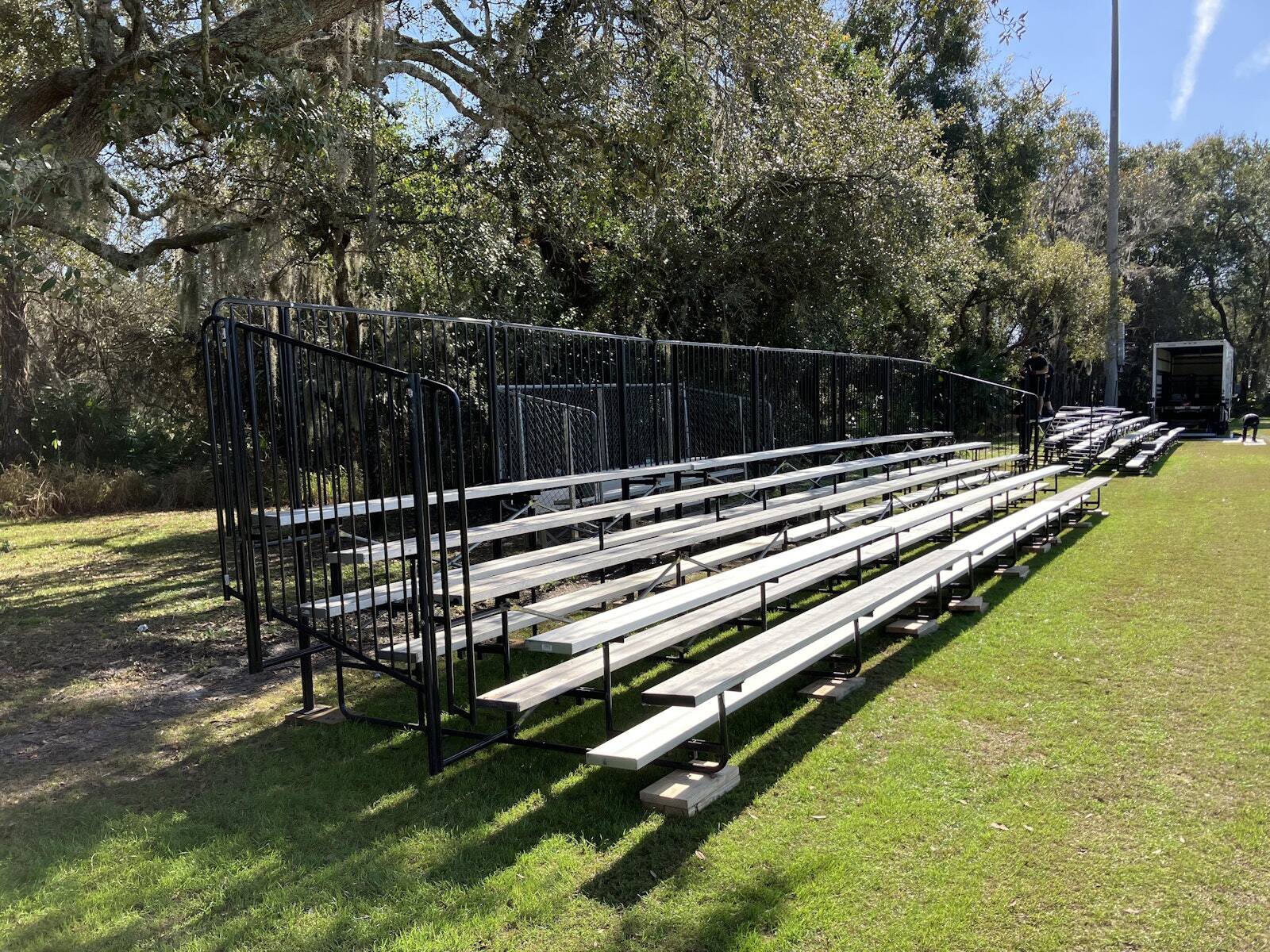 Portable PM1 bleachers set on a grass field
