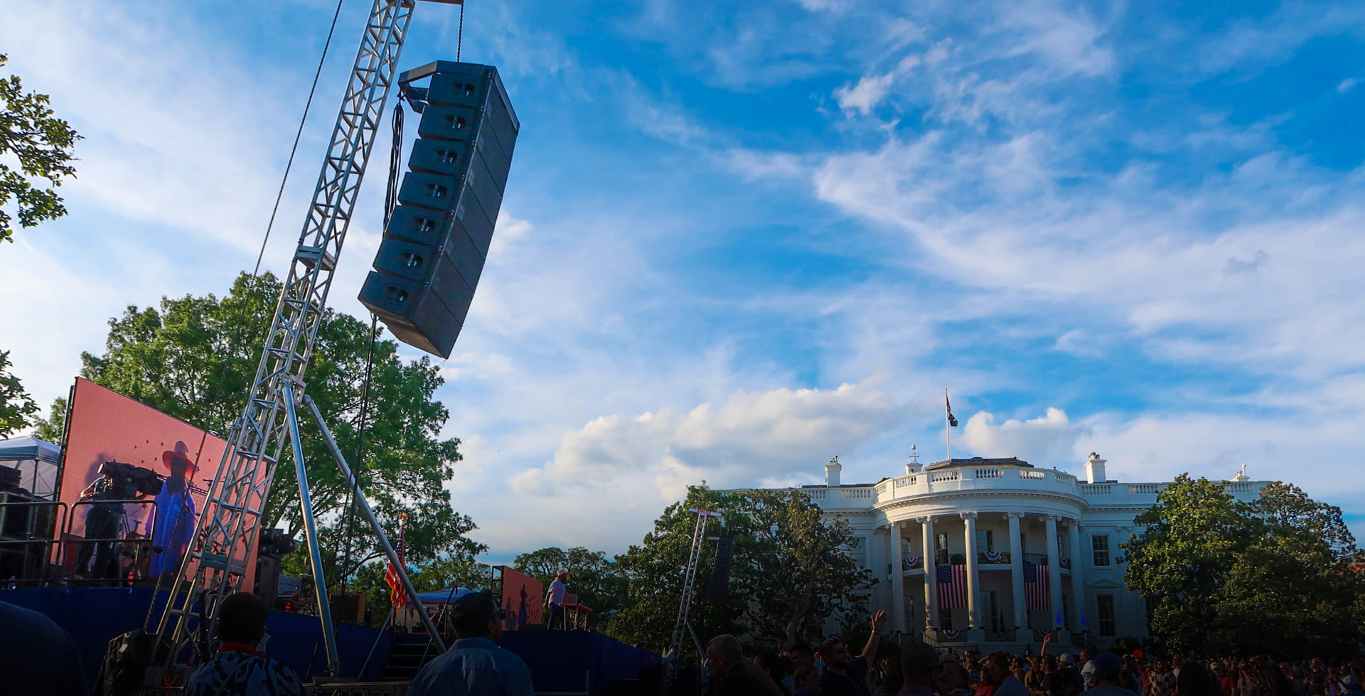 Line array speaker hung from a truss tower beside a stage on the White House South Lawn