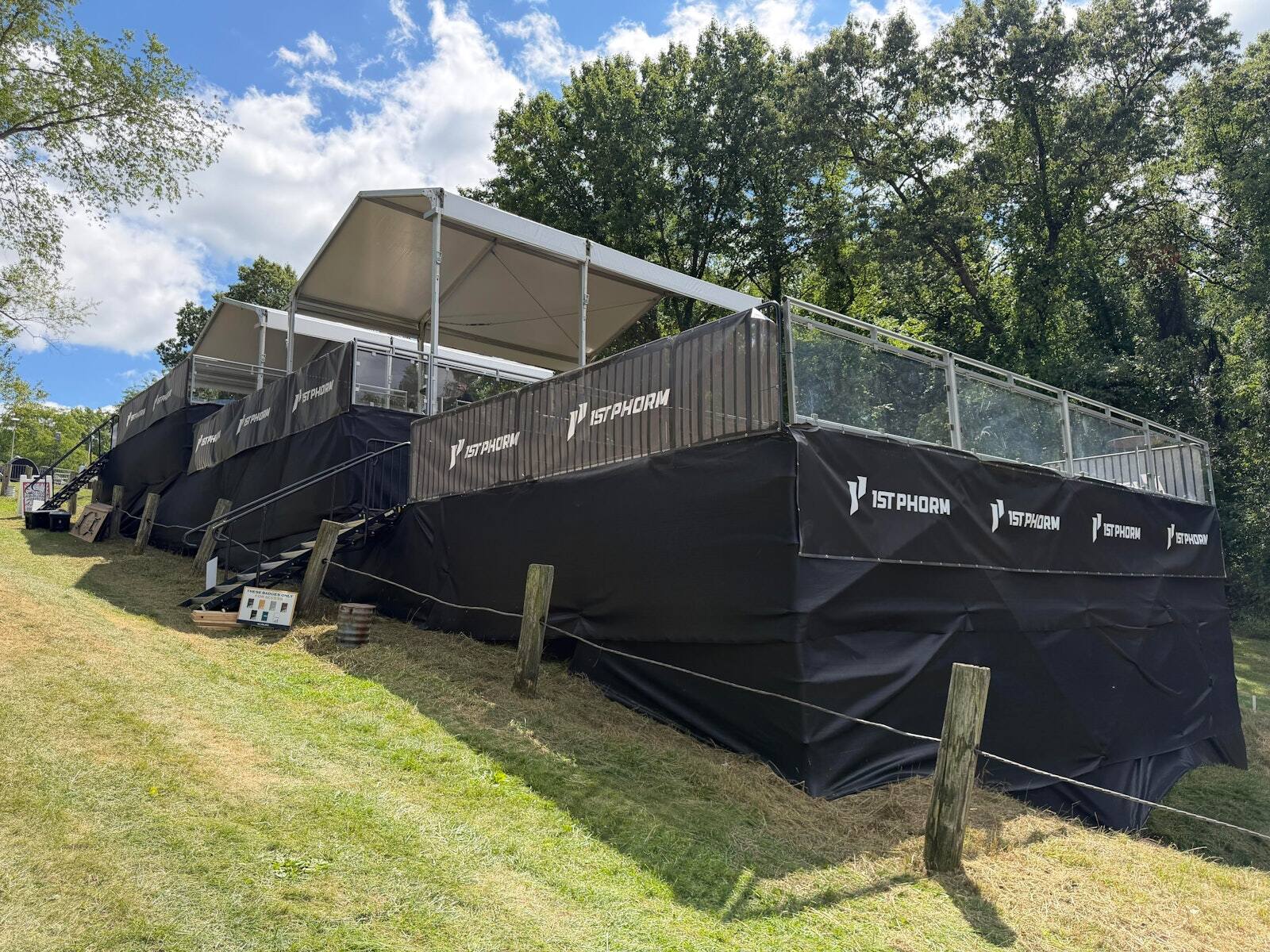 Covered sponsor viewing platforms on grass at the 2026 PDGA Worlds
